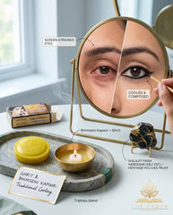 Advertisement for Bhimseni Kapoor + Ghrit with a mirror showing eye makeup application and products on a table.